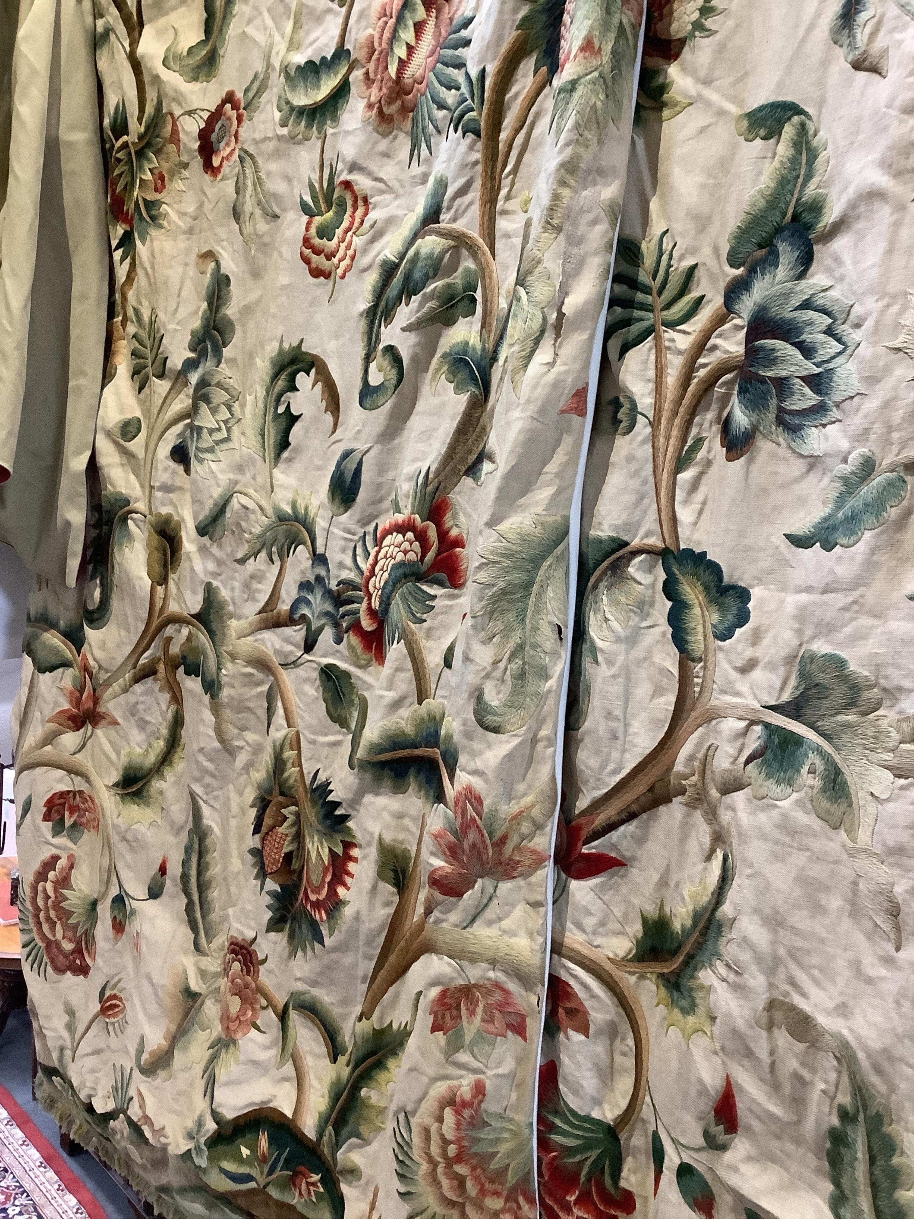 Six 20th century crewel work ‘Tree of Life’ cream linen curtains. Worked at the base in coloured wools depicting a pastoral scene of a shepherd playing a flute amongst sheep, deer, squirrels and flowers with a dog chasin